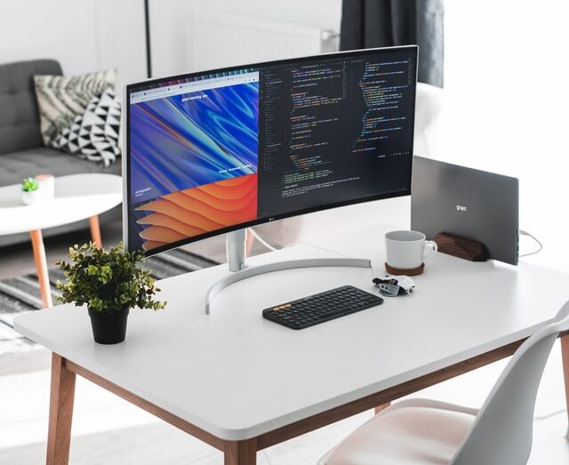 Aesthetic desk setup with vertically docked macbook
