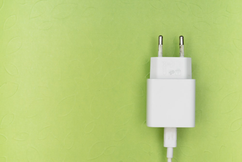white adapter on green wall