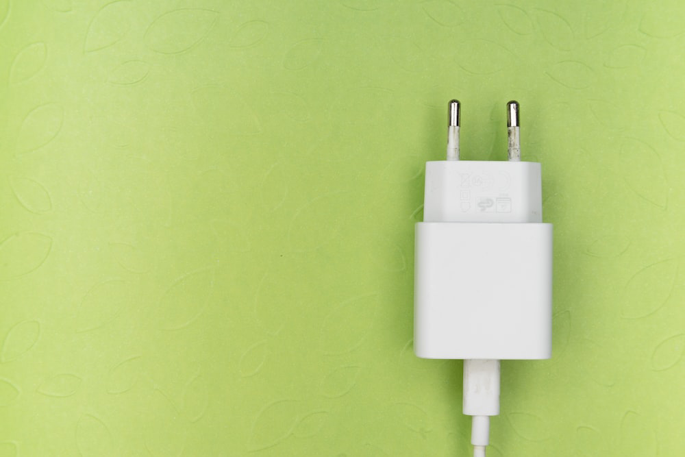 white adapter on green wall