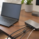ThinkPad docking station connected to a ThinkPad laptop by USB-C, with cables fanning out across a desk