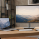 Thin laptop beside a desktop monitor in a bright home office