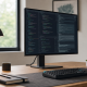 Coding and programming monitor on a developer desk showing code, terminal, and documentation panes.