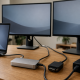 Generic dual-monitor Thunderbolt desk setup illustrating display adapters and power