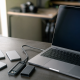 Thunderbolt 5 external SSDs and NVMe enclosures beside a laptop