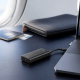Laptop connected by USB-C to a compact cellular modem on a travel work desk