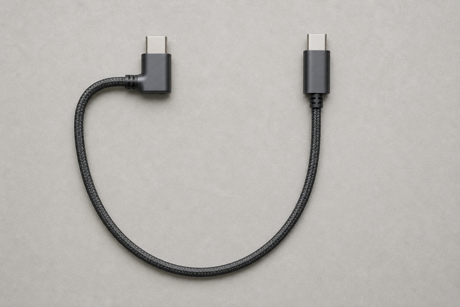 Unbranded USB-C cable with one right-angle plug and one straight plug arranged to compare cable exit direction.